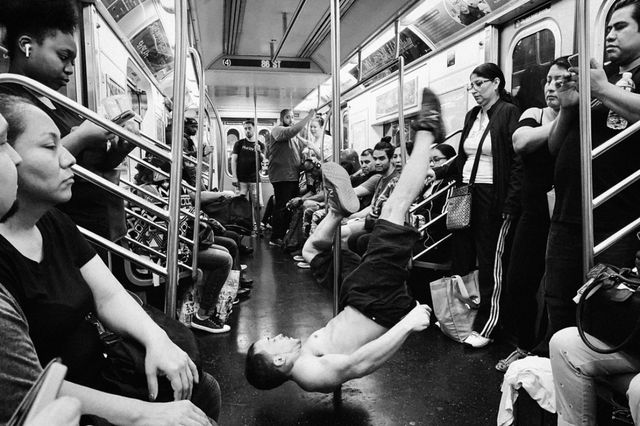 A photo of a shirtless Showtime dancer on the subway